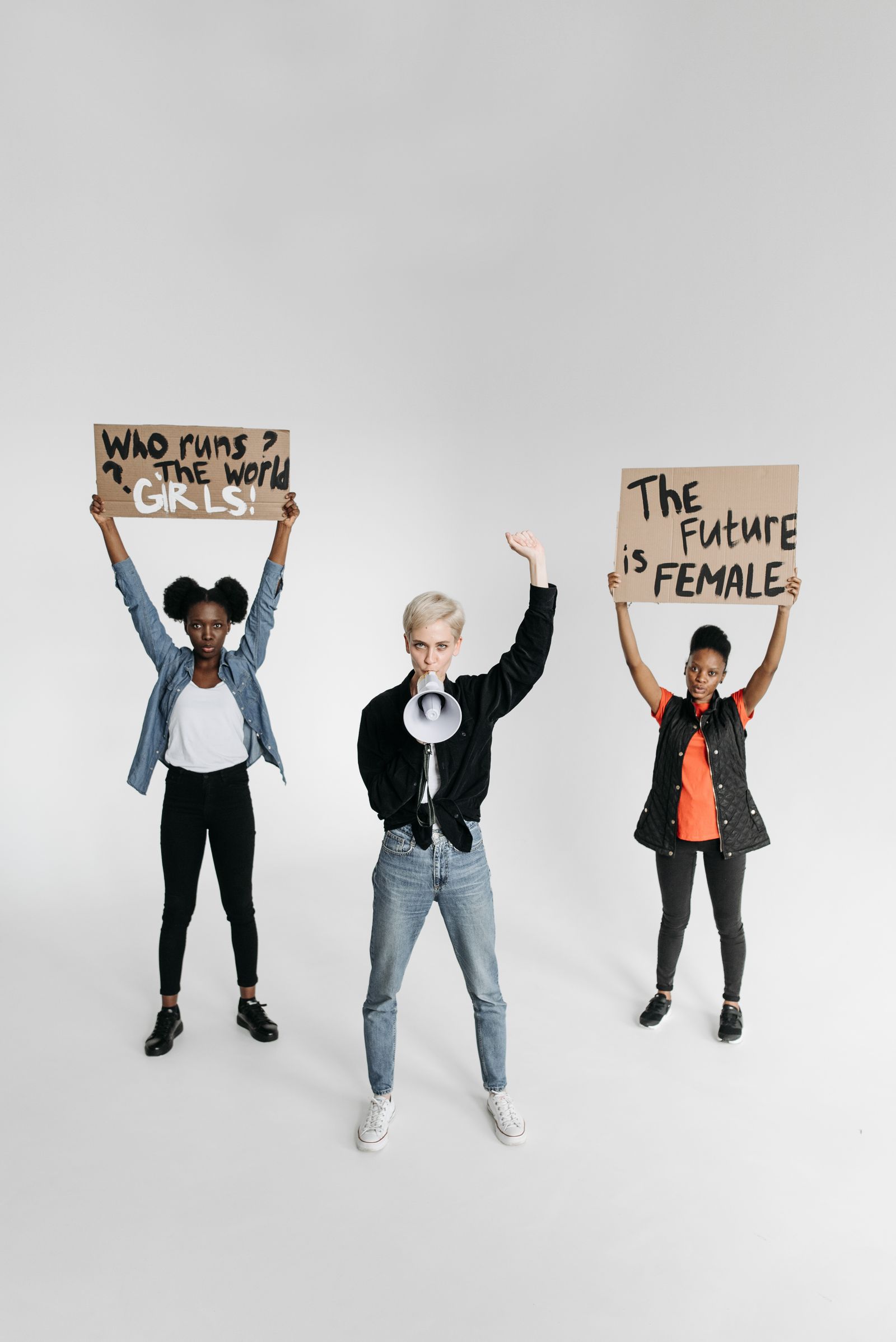 Young Black women holding "The Future is Female" rally signs